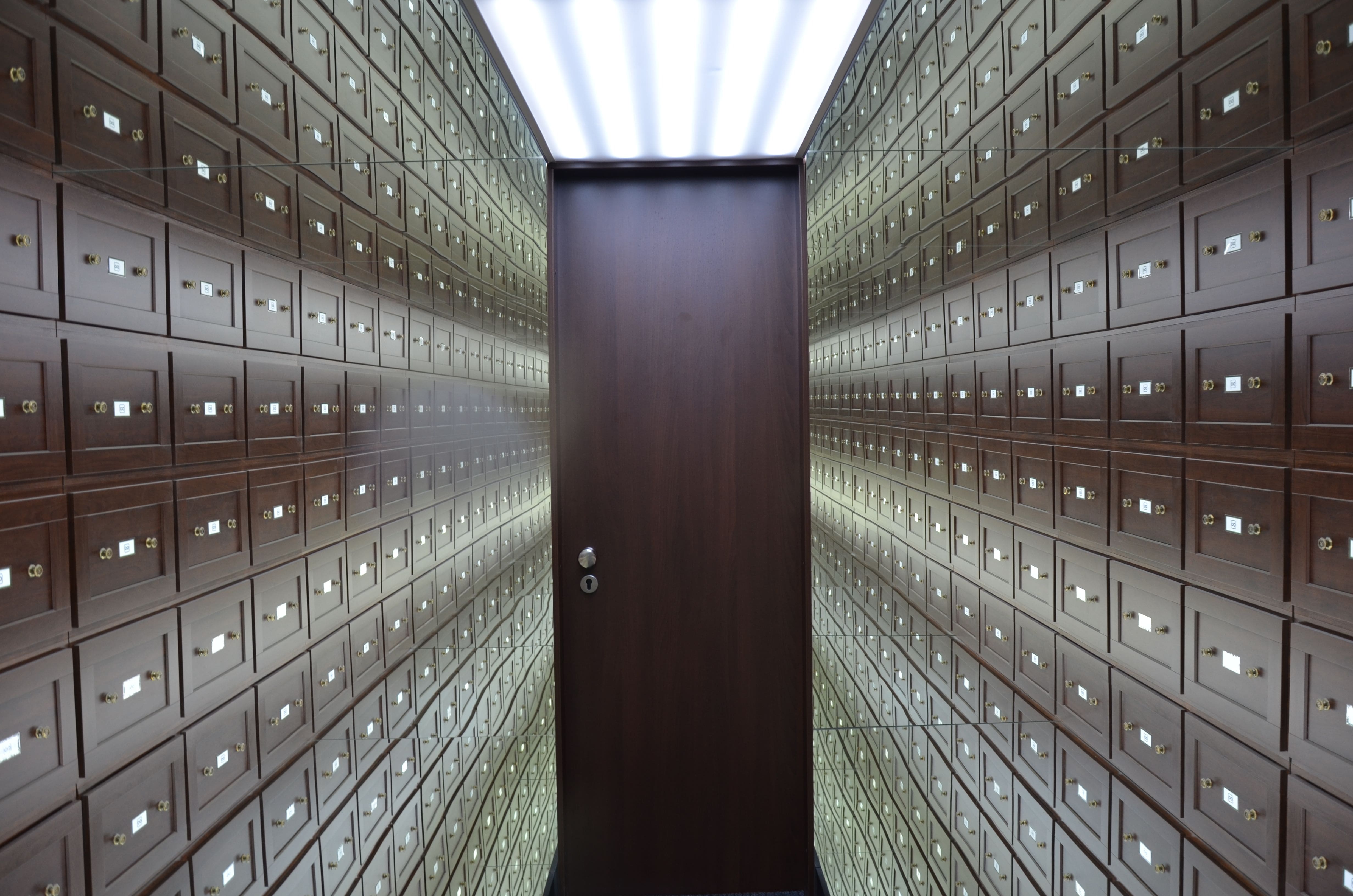 Secure deposit boxes within a controlled vault environment
