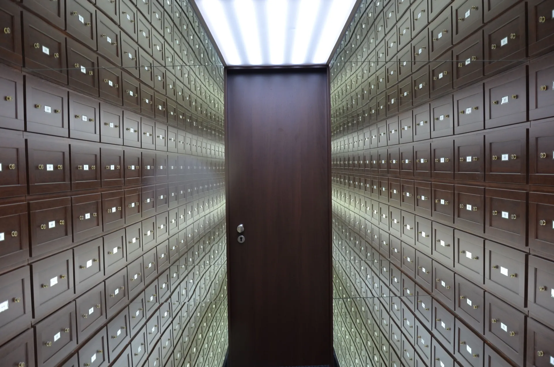 Secure deposit boxes within a controlled vault environment