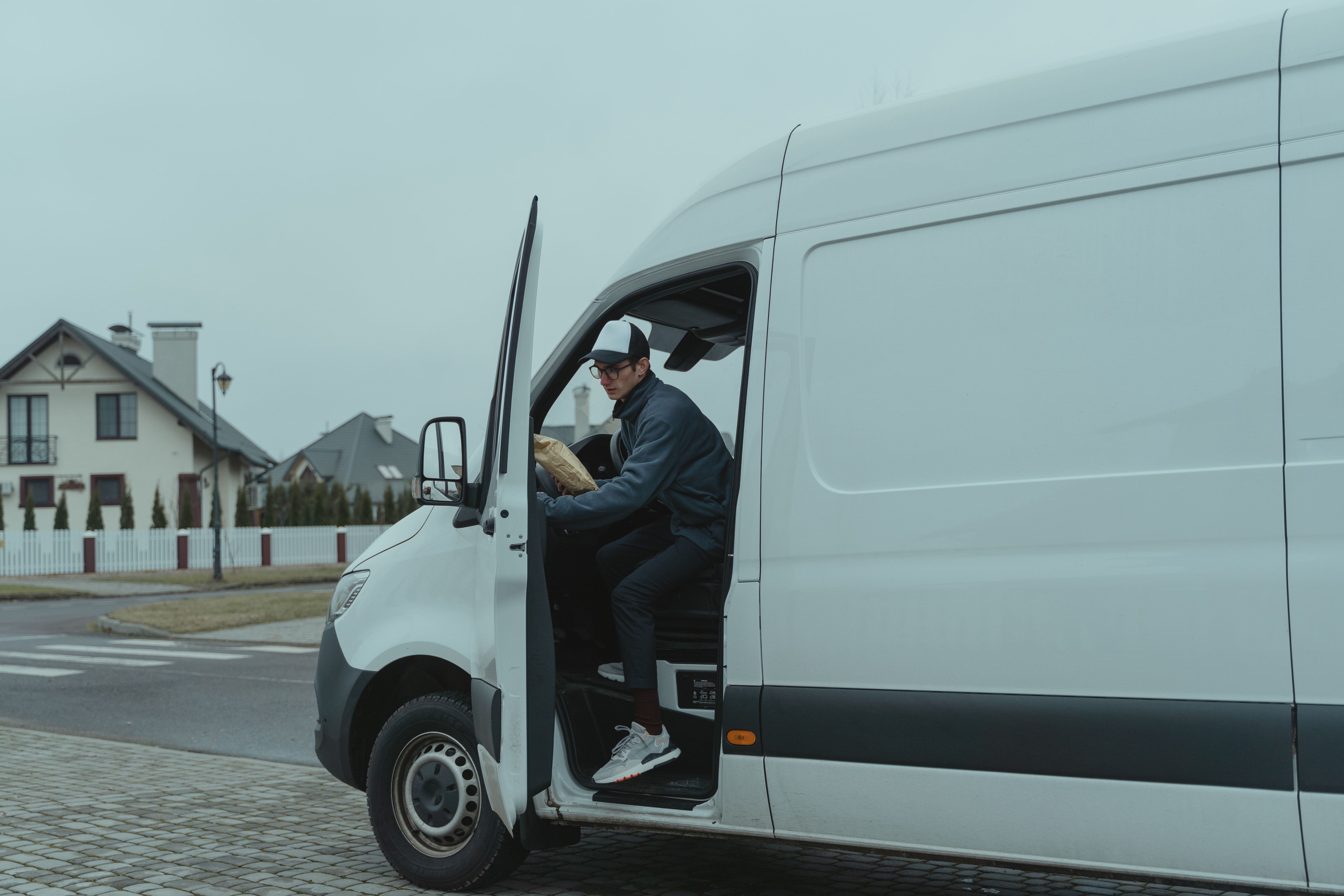 Delivery professional stepping from a cargo van